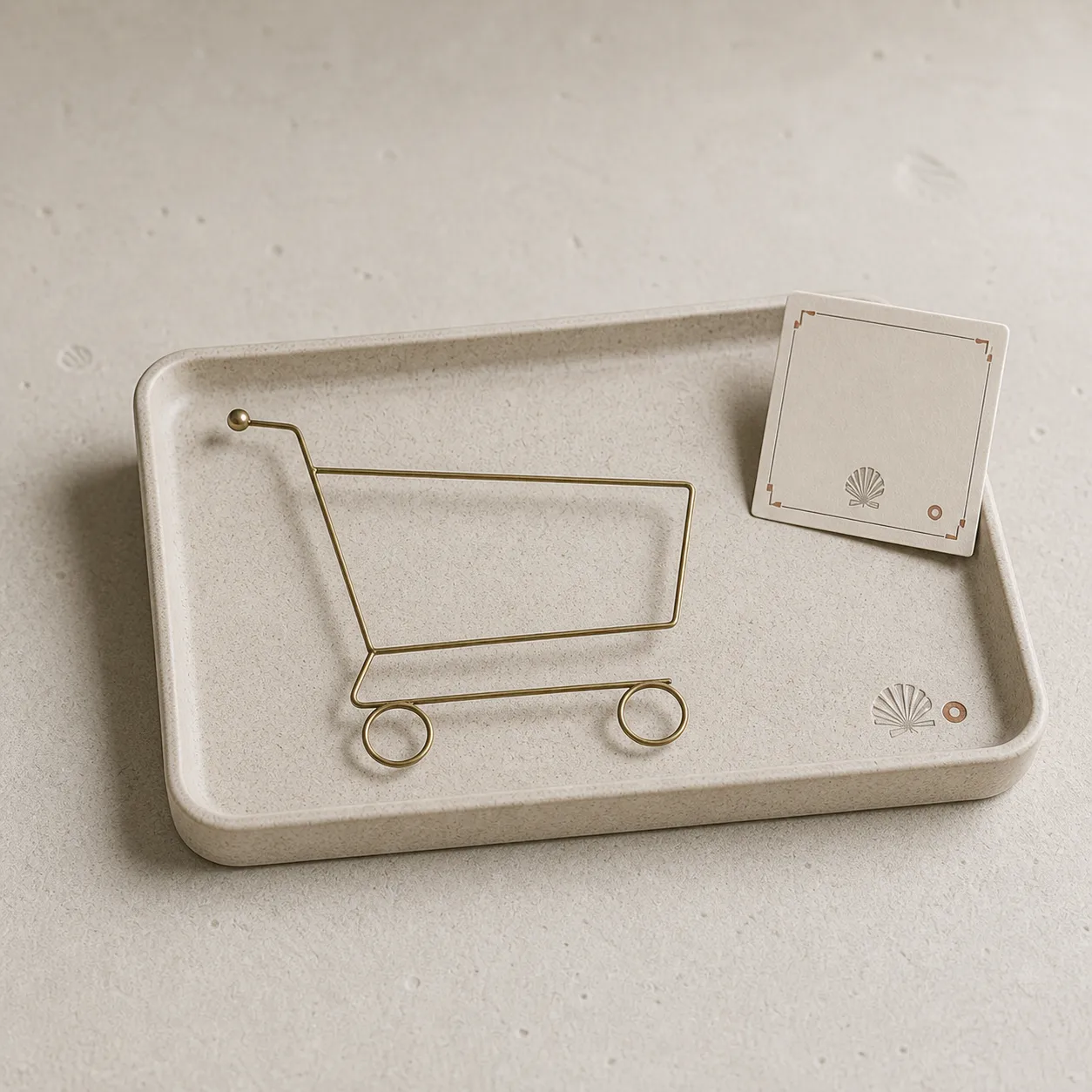 Product photograph of an empty display tray with a small brass outline of a shopping cart.